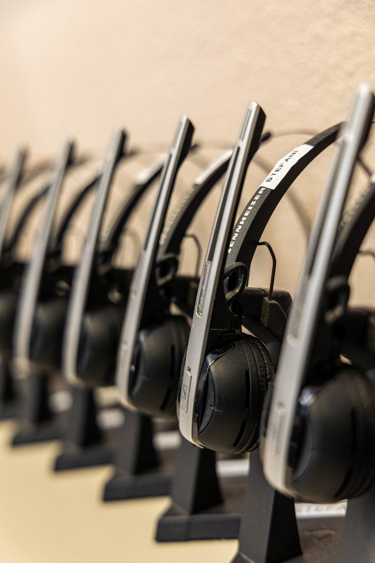 A row of headsets used for incoming service calls.