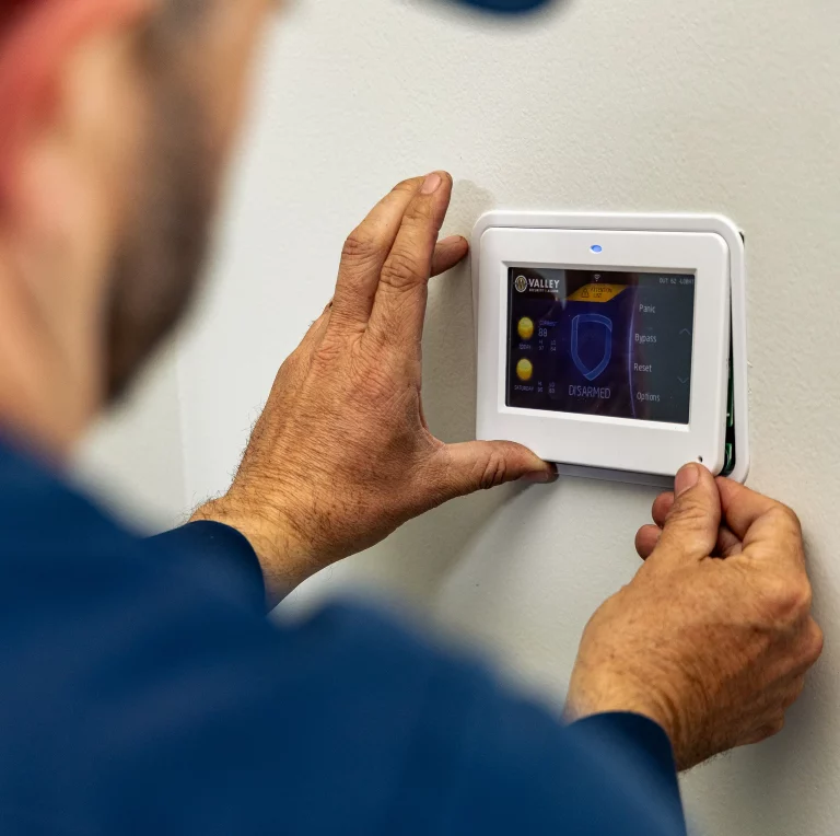 Service technician installing an access control device.