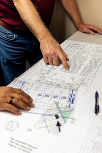 Two people looking at security installation plans.