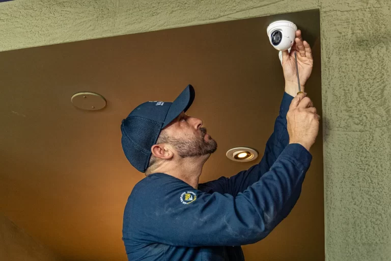 Alarm technician installing cctv camera.