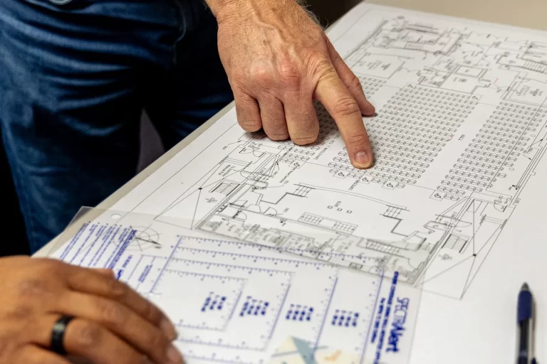 NICET Certified alarm system planners looking at blueprints