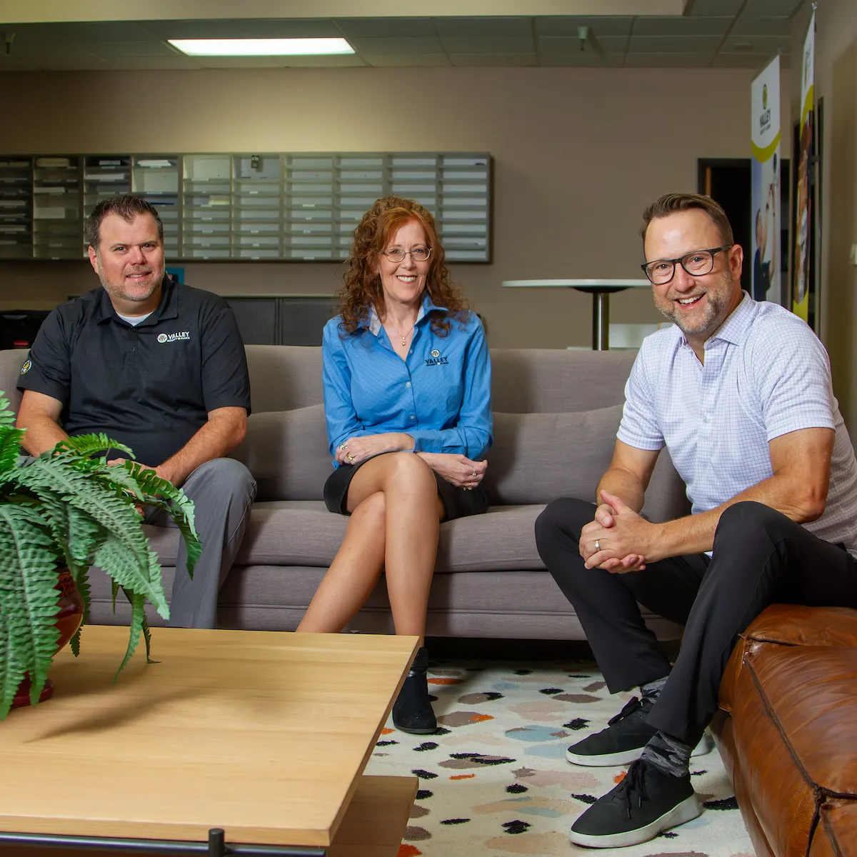 Three VSA employees sitting on couches in a meeting area